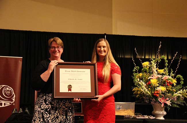 Gabrielle Lessen receives the Brown Foundation-Earl Rudder Memorial Outstanding Student Award at Texas A&M University.