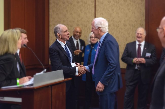 Texas A&M President Michael K. Young (left) greets Texas Senator and Senate Majority Whip John Cornyn (right) during an Aggies on the Hill reception.