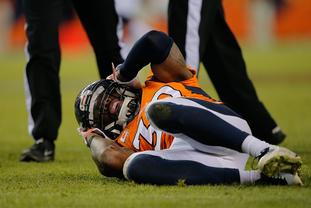 Strong safety David Bruton #30 of the Denver Broncos lies on the ground in pain after a play that would force him out of the game with a reported concussion during a game against the Oakland Raiders at Sports Authority Field at Mile High on December 28, 2014 in Denver, Colorado.  (Doug Pensinger/Getty Images)