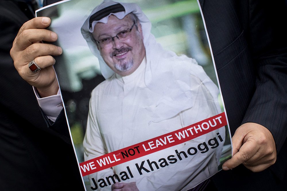 ISTANBUL, TURKEY - OCTOBER 08: A man holds a poster of Saudi journalist Jamal Khashoggi during a protest organized by members of the Turkish-Arabic Media Association at the entrance to Saudi Arabia's consulate on October 8, 2018 in Istanbul, Turkey. Fears are growing over the fate of missing journalist Jamal Khashoggi after Turkish officials said they believe he was murdered inside the Saudi consulate. Saudi consulate officials have said that missing writer and Saudi critic Jamal Khashoggi went missing after leaving the consulate, however the statement directly contradicts other sources including Turkish officials. Jamal Khashoggi a Saudi writer critical of the Kingdom and a contributor to the Washington Post was living in self-imposed exile in the U.S. (Photo by Chris McGrath/Getty Images)