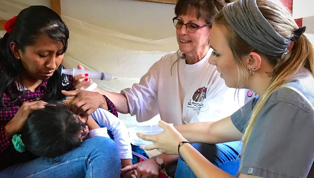 A team of nurses administering aid to a woman in Quillabamba