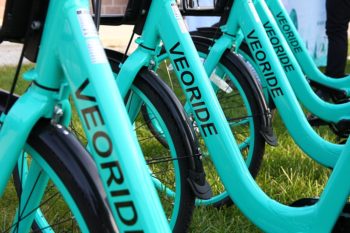a photo of five VeoRide bikes lined up side-by-side